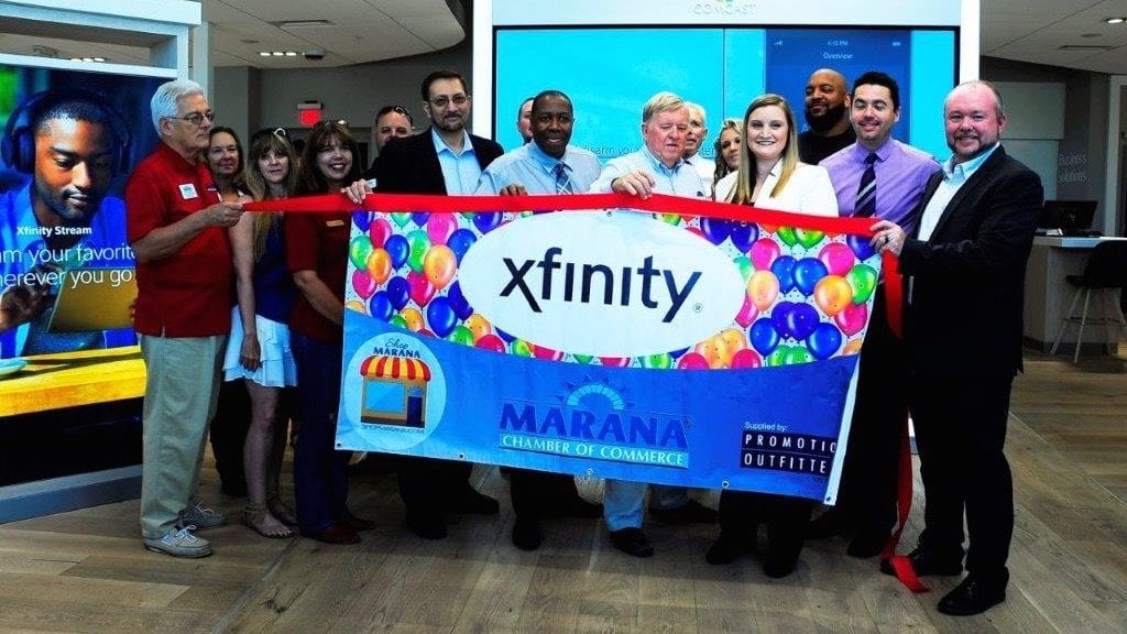 Group of people holding Xfinity sign