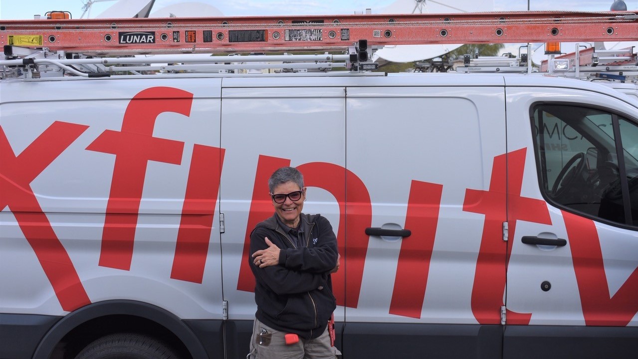 Vickie Jo standing in front of her Xfinity van.